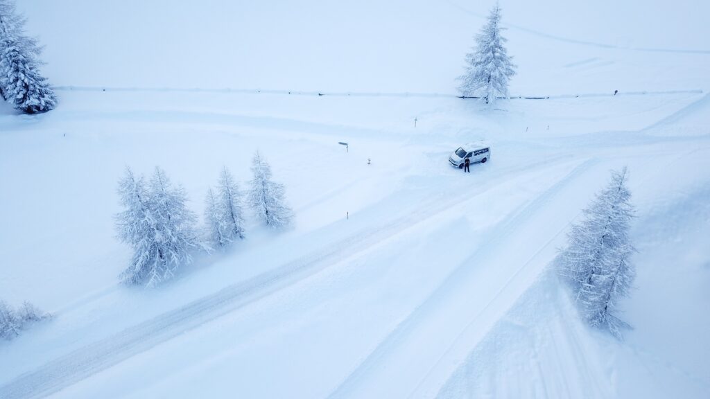 White campervan in a snowy winter landscape