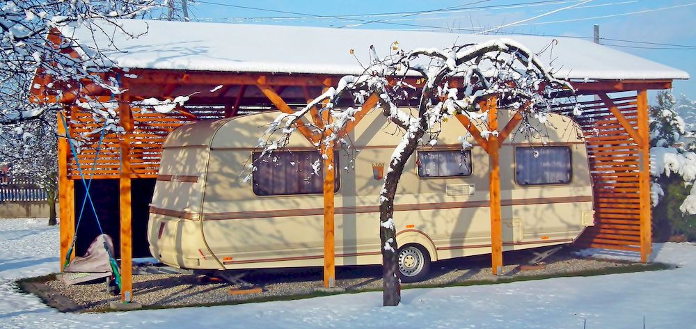 Caravan under a roof in winter climate