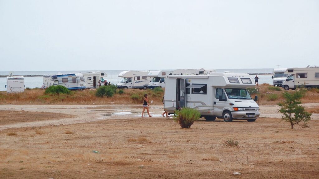 Several motorhomes parked on the coast