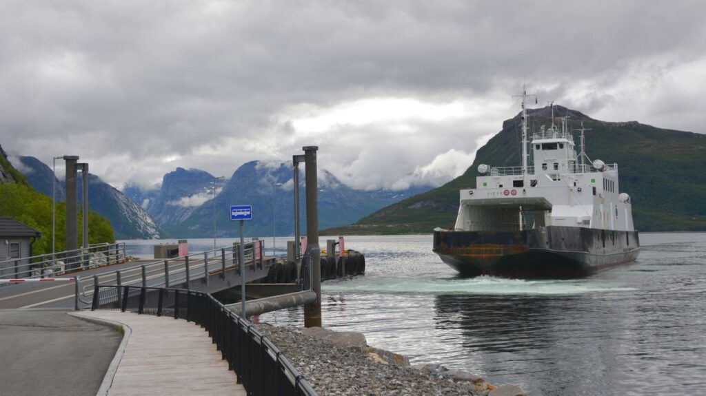 A ferry with mountains in the background