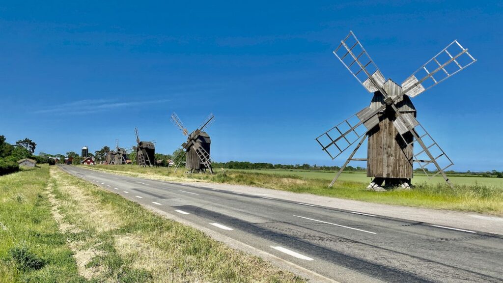 Several windmills in a row, along a road