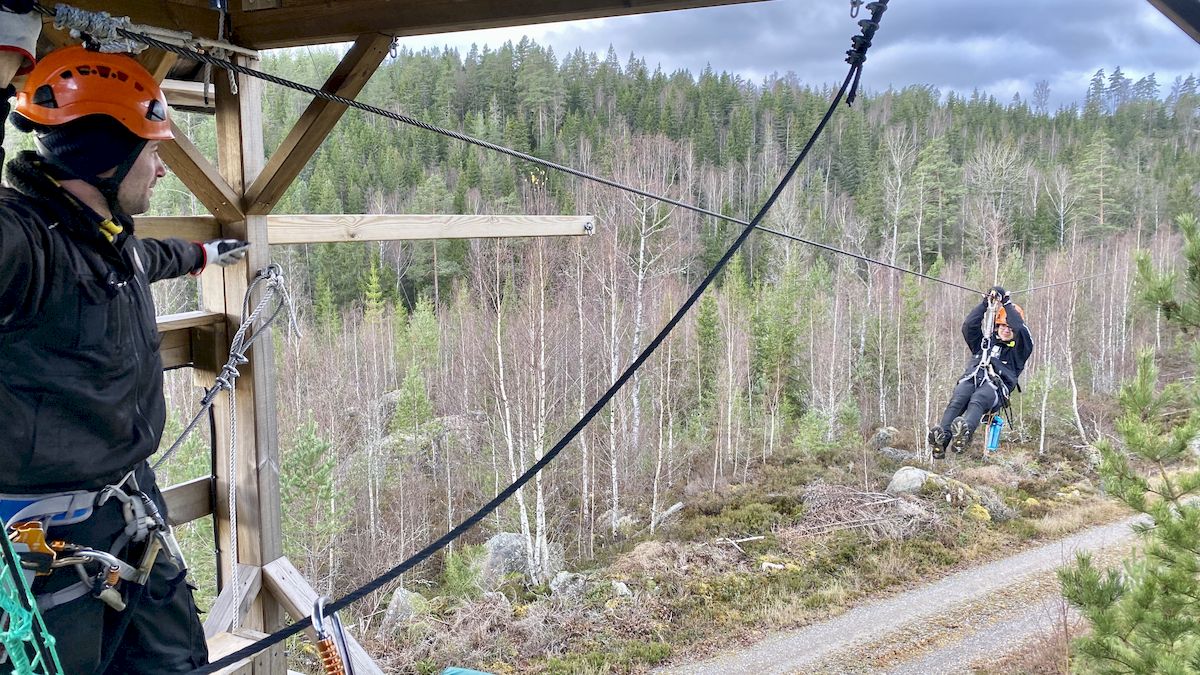  One person rides the zipline and one person waits
